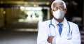 senior black male doctor at hospital wearing mask