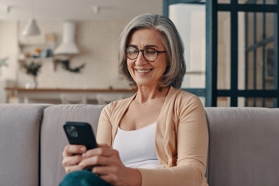 Woman with cell phone viewing news and updates